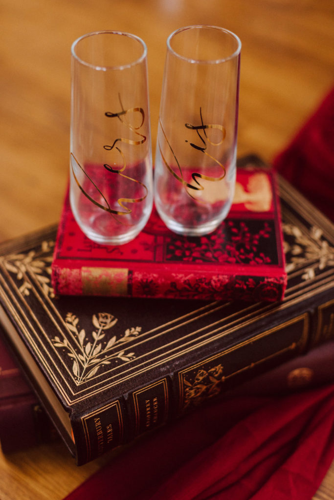 vintage books with his & her wine glasses