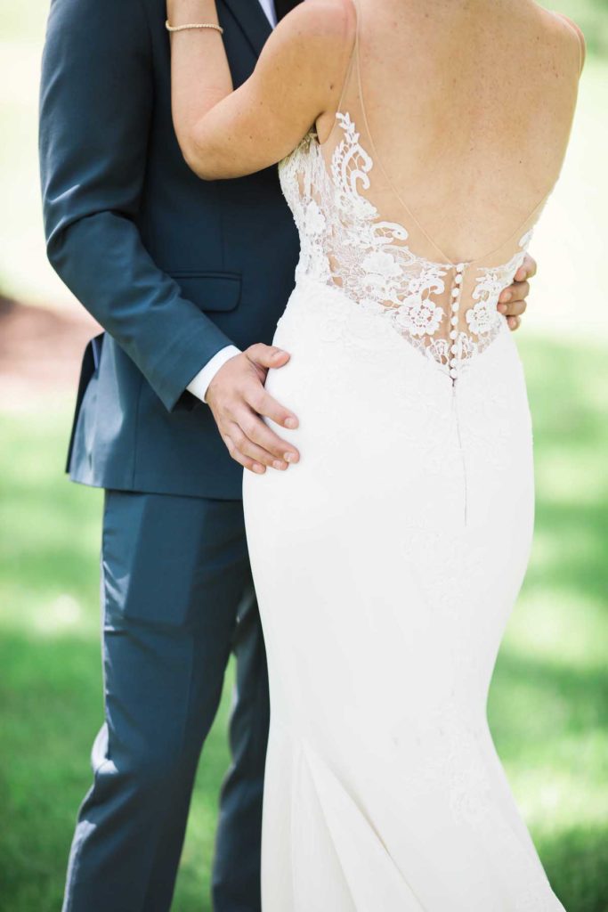 Close of of bride and groom holding each other