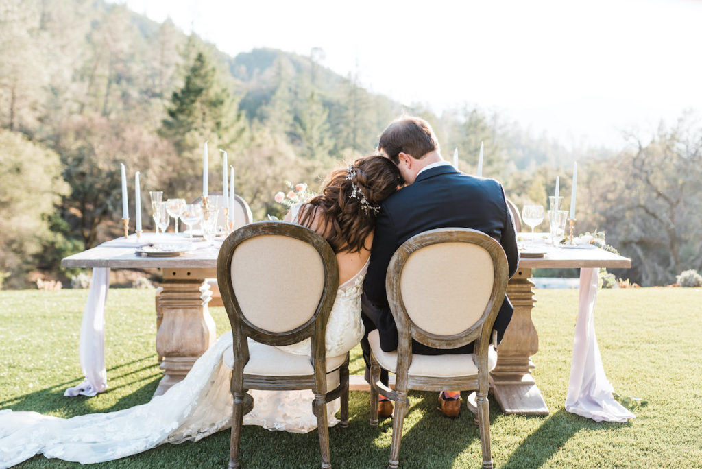 bride rests head on grooms shoulder during reception at Calistoga Ranch