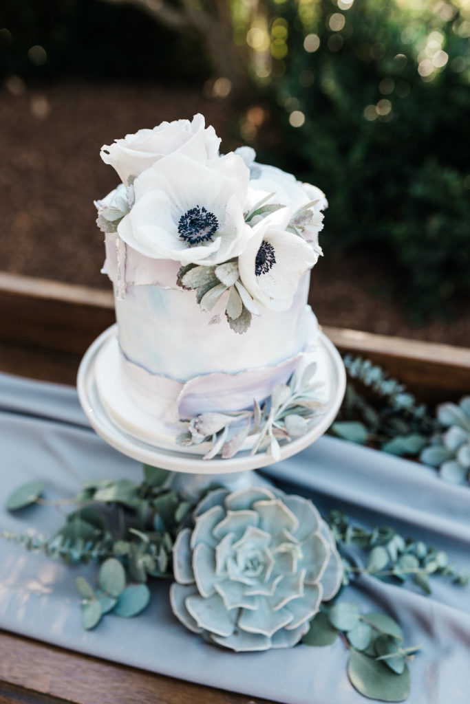 wedding cake with white anemones and succulents at Calistoga Ranch